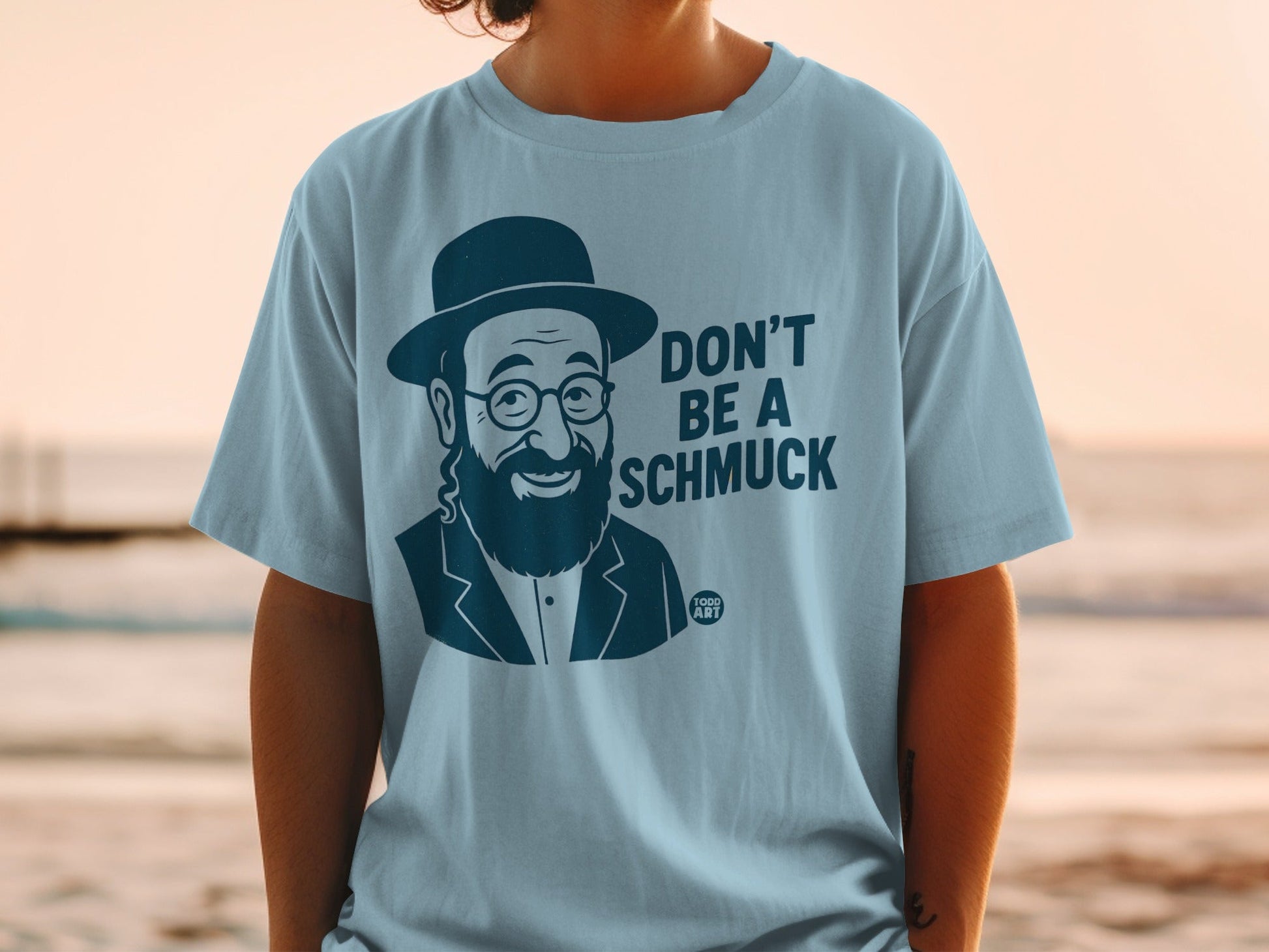 Light blue t-shirt with "DON'T BE A SCHMUCK" and a caricature of a man.