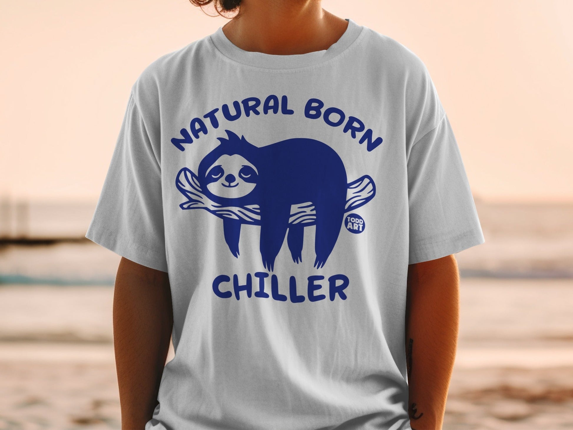 White t-shirt with blue text and graphic of a sloth on a branch.