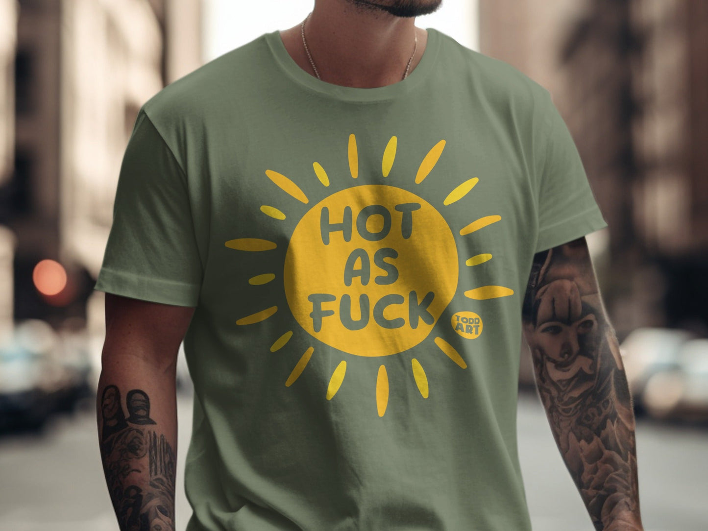 Green t-shirt with yellow sun graphic and "HOT AS FUCK" text.