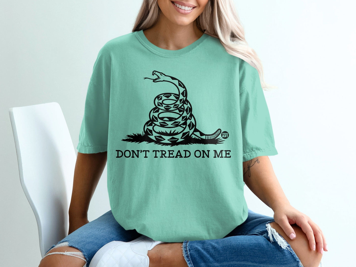 Teal t-shirt with coiled rattlesnake and "Don't Tread On Me" text.