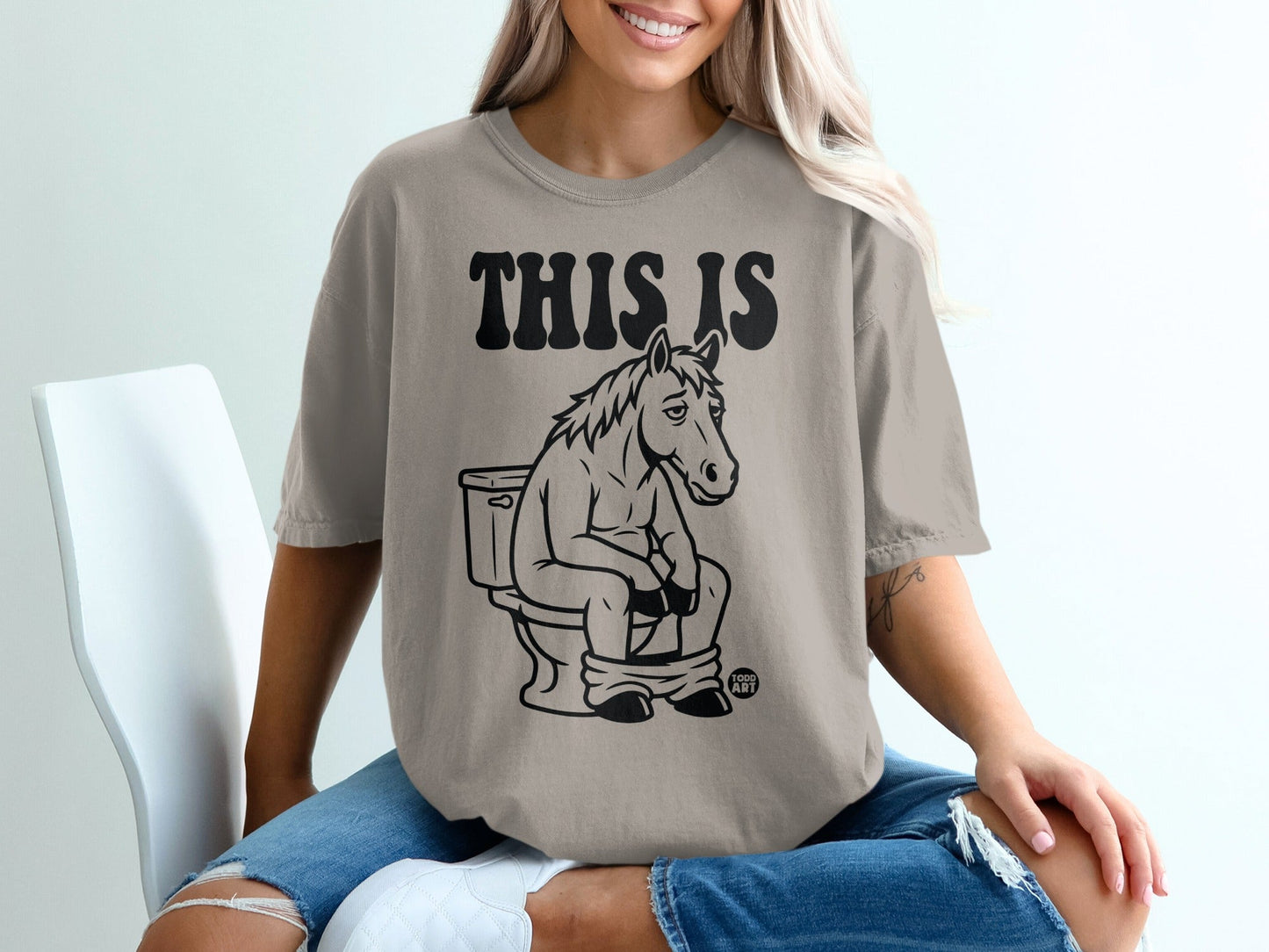 Horse sitting on a toilet with text "THIS IS" above.