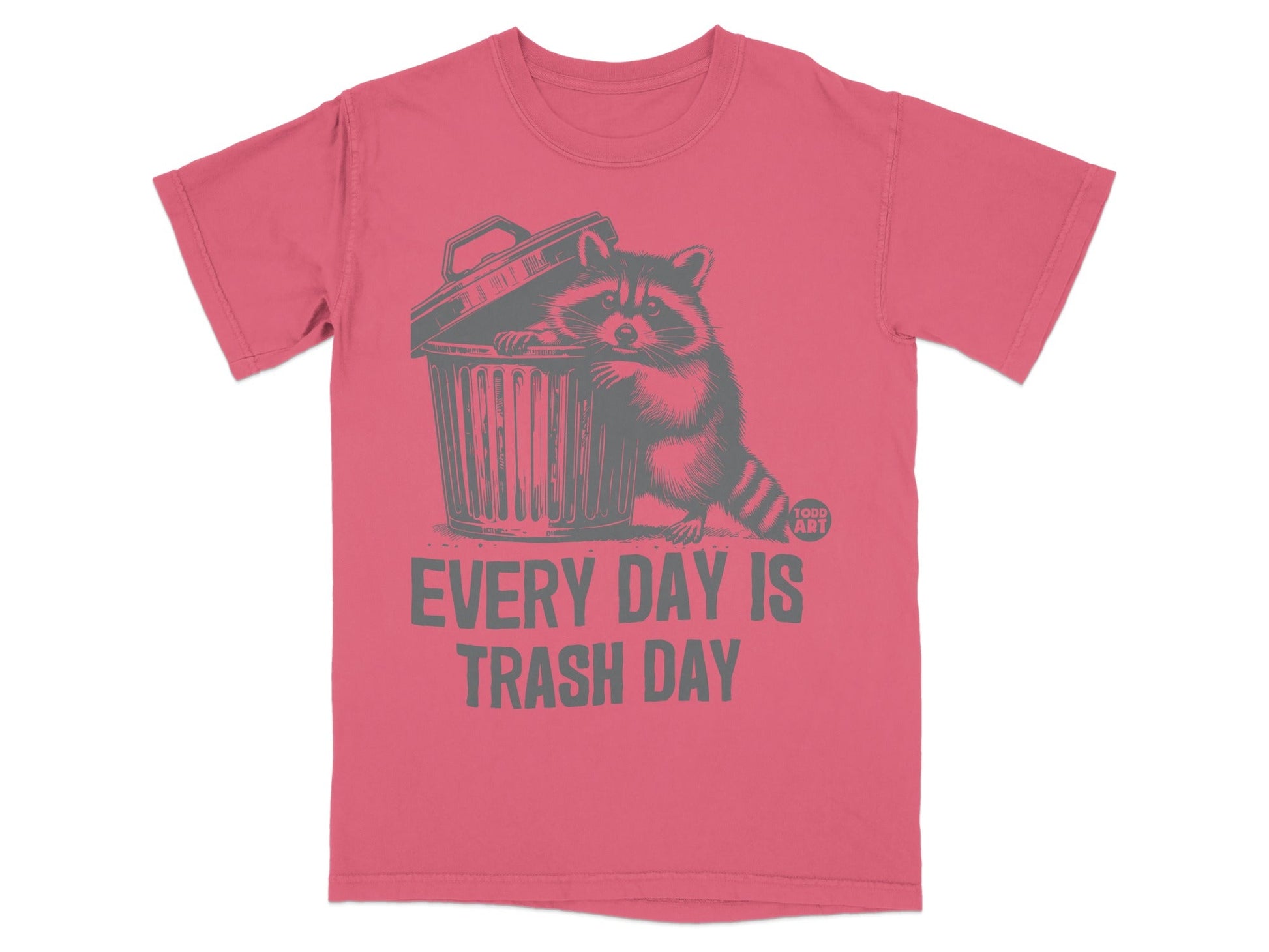 Pink t-shirt with raccoon peeking from trash can, text "EVERY DAY IS TRASH DAY".
