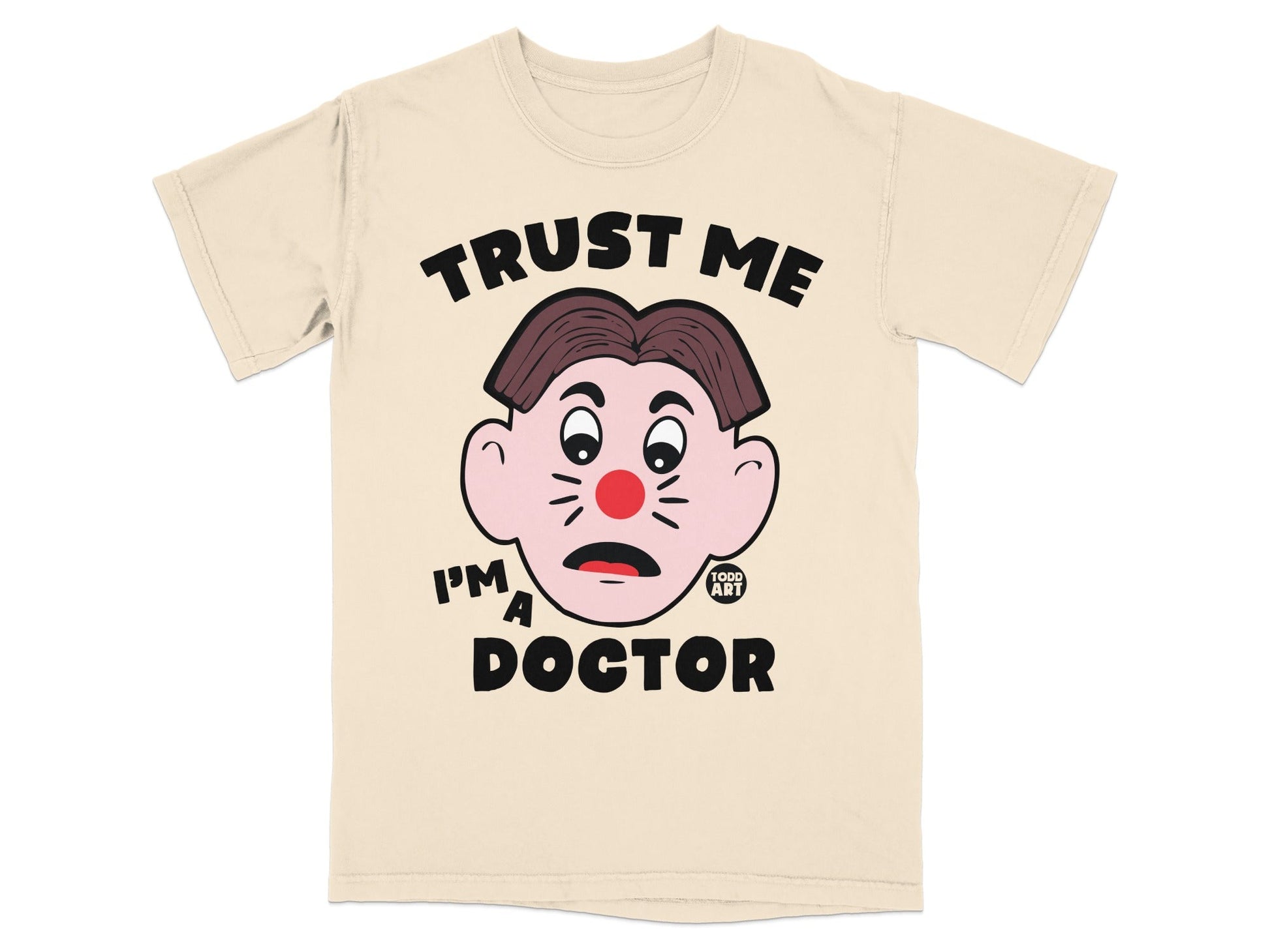 Beige t-shirt with "TRUST ME I'M A DOCTOR" and a clown face graphic.