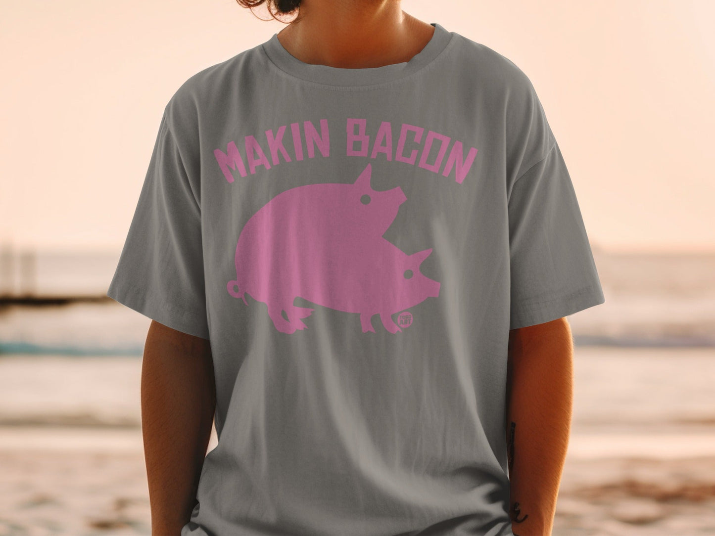 Gray t-shirt with pink "Makin Bacon" text and two pigs.