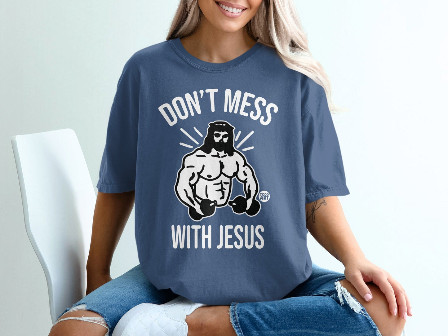 Blue t-shirt with "Don't Mess With Jesus" and muscular Jesus graphic.