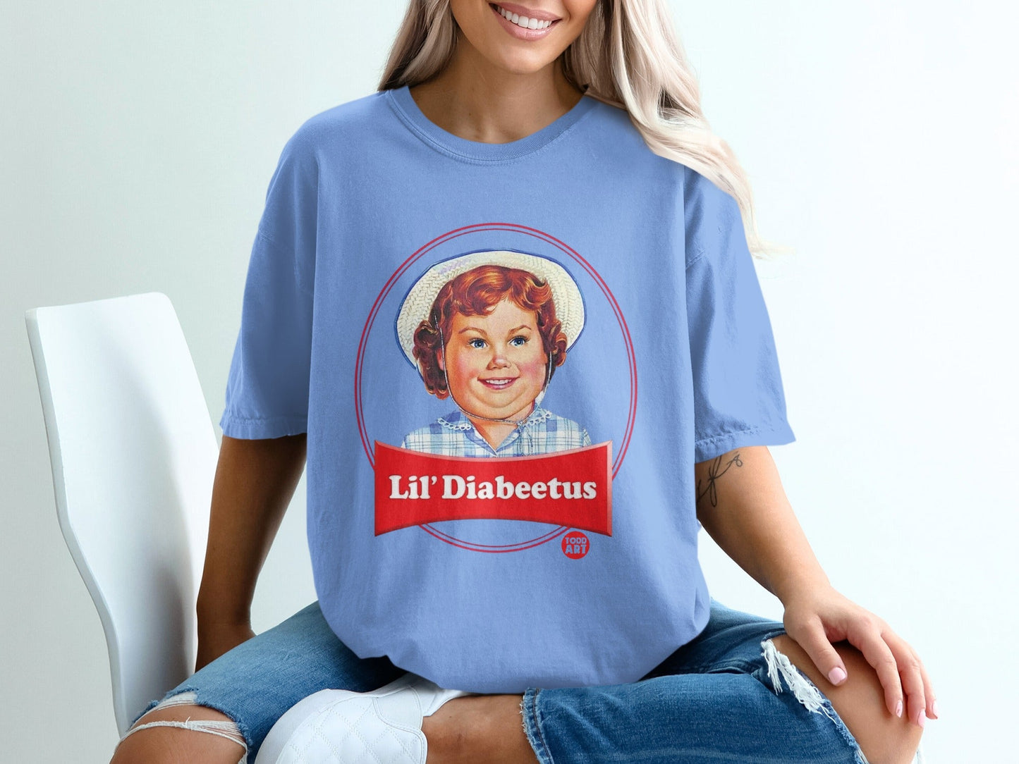 Lil' Diabeetus logo on a light blue t-shirt worn by a person.