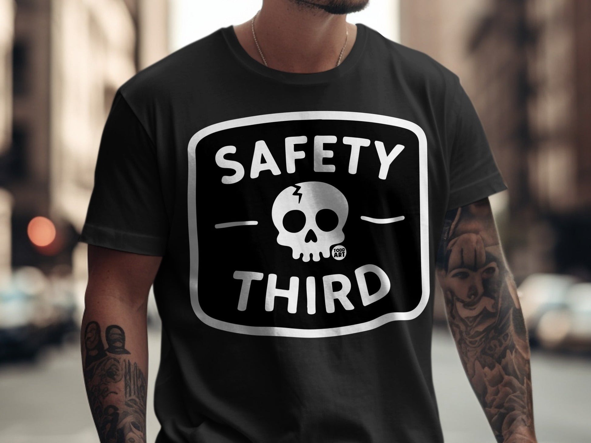 Black t-shirt with white "SAFETY THIRD" text and skull logo.