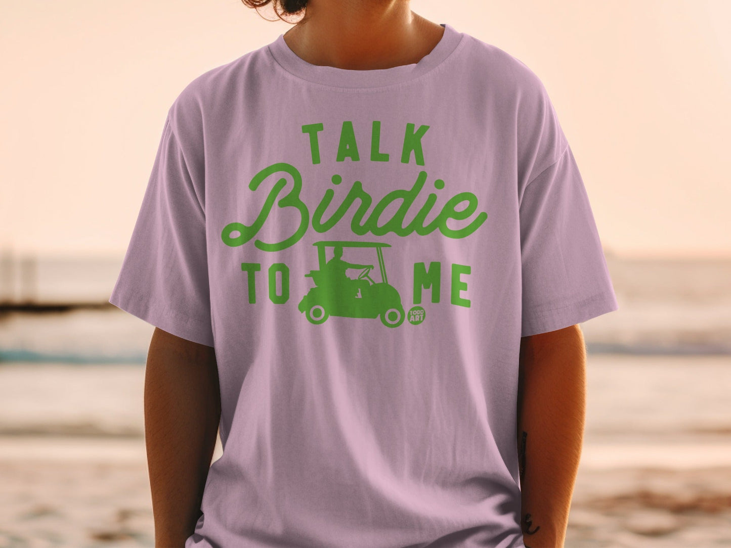Purple t-shirt with "Talk Birdie to Me" text and golf cart graphic.