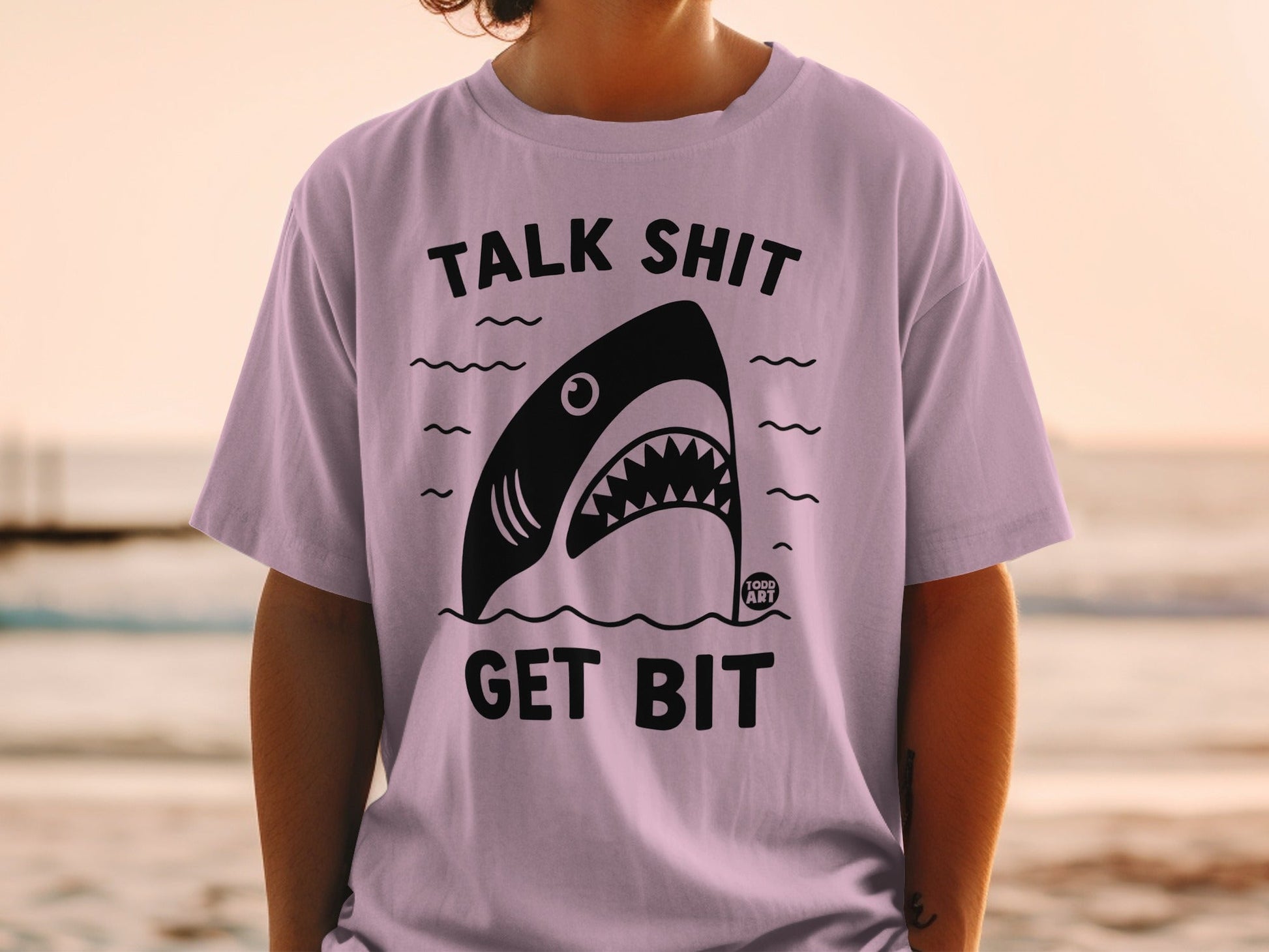 Purple t-shirt with shark graphic and "TALK SHIT GET BIT" text.