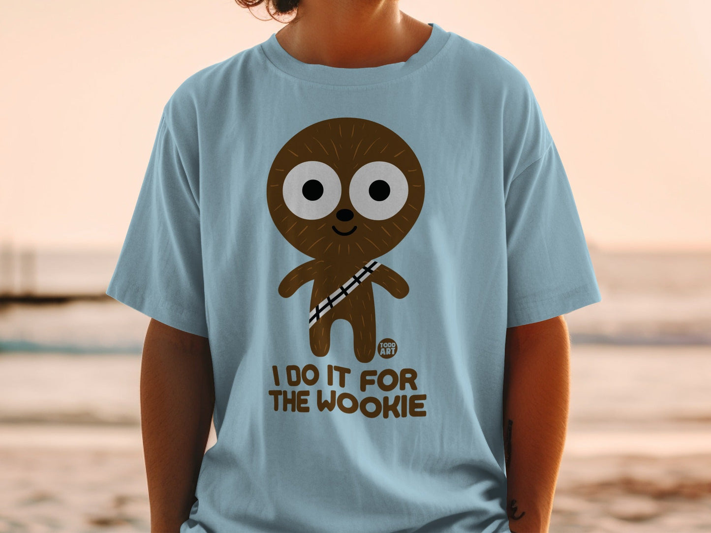 Light blue t-shirt with a cartoon Wookiee character and "I DO IT FOR THE WOOKIE" text.