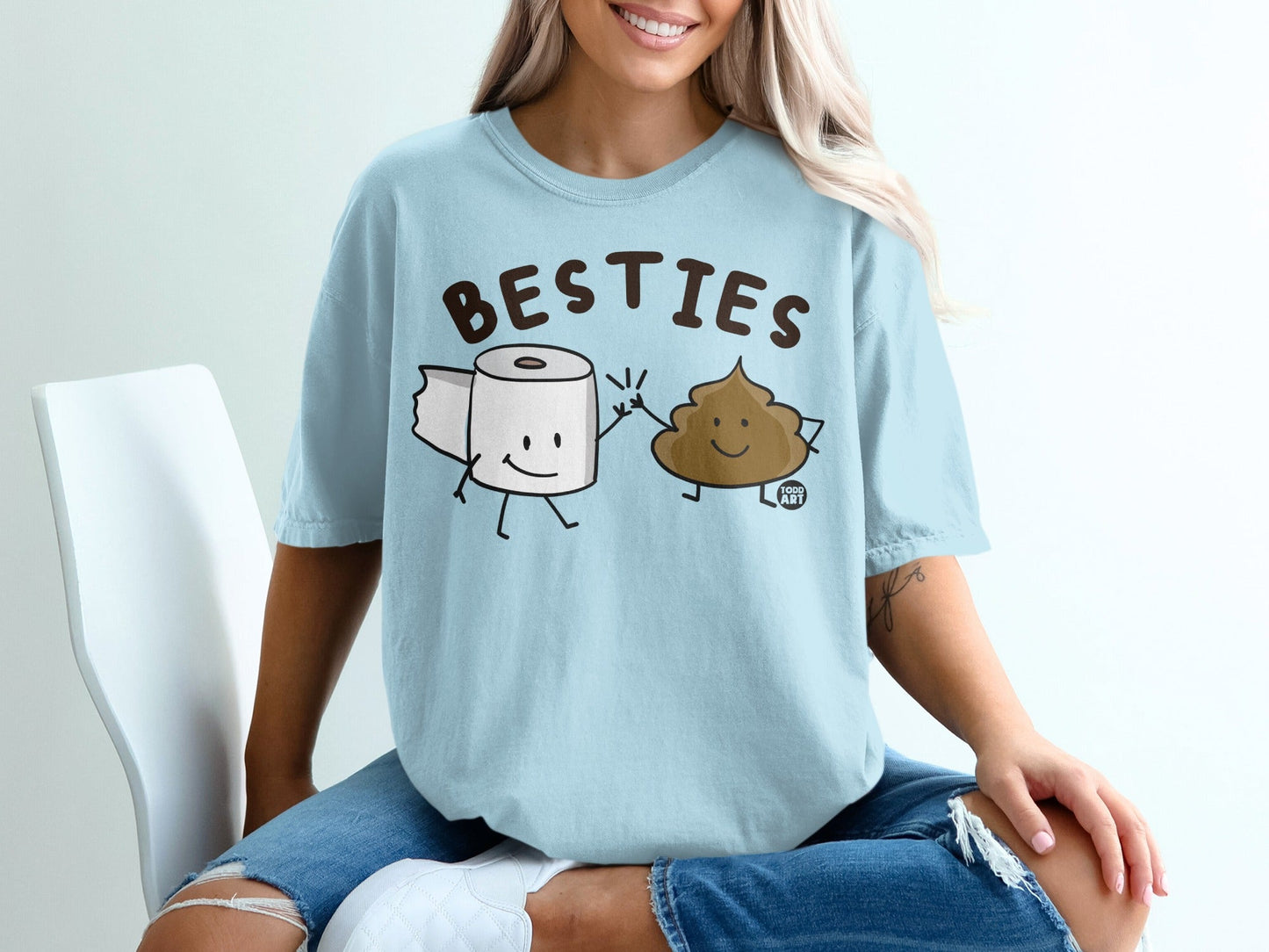 T-shirt graphic of two smiling characters: a roll of toilet paper and a piece of poop.