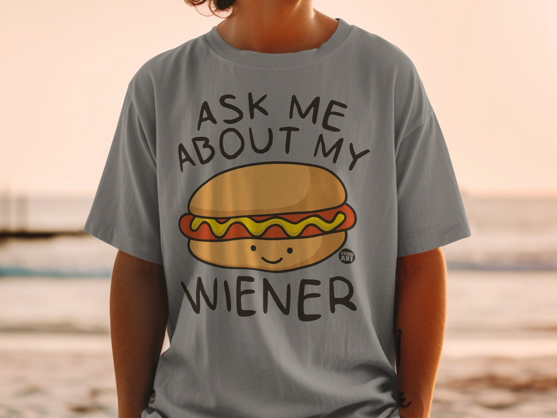 Gray t-shirt with a hot dog graphic and text "Ask Me About My Wiener".