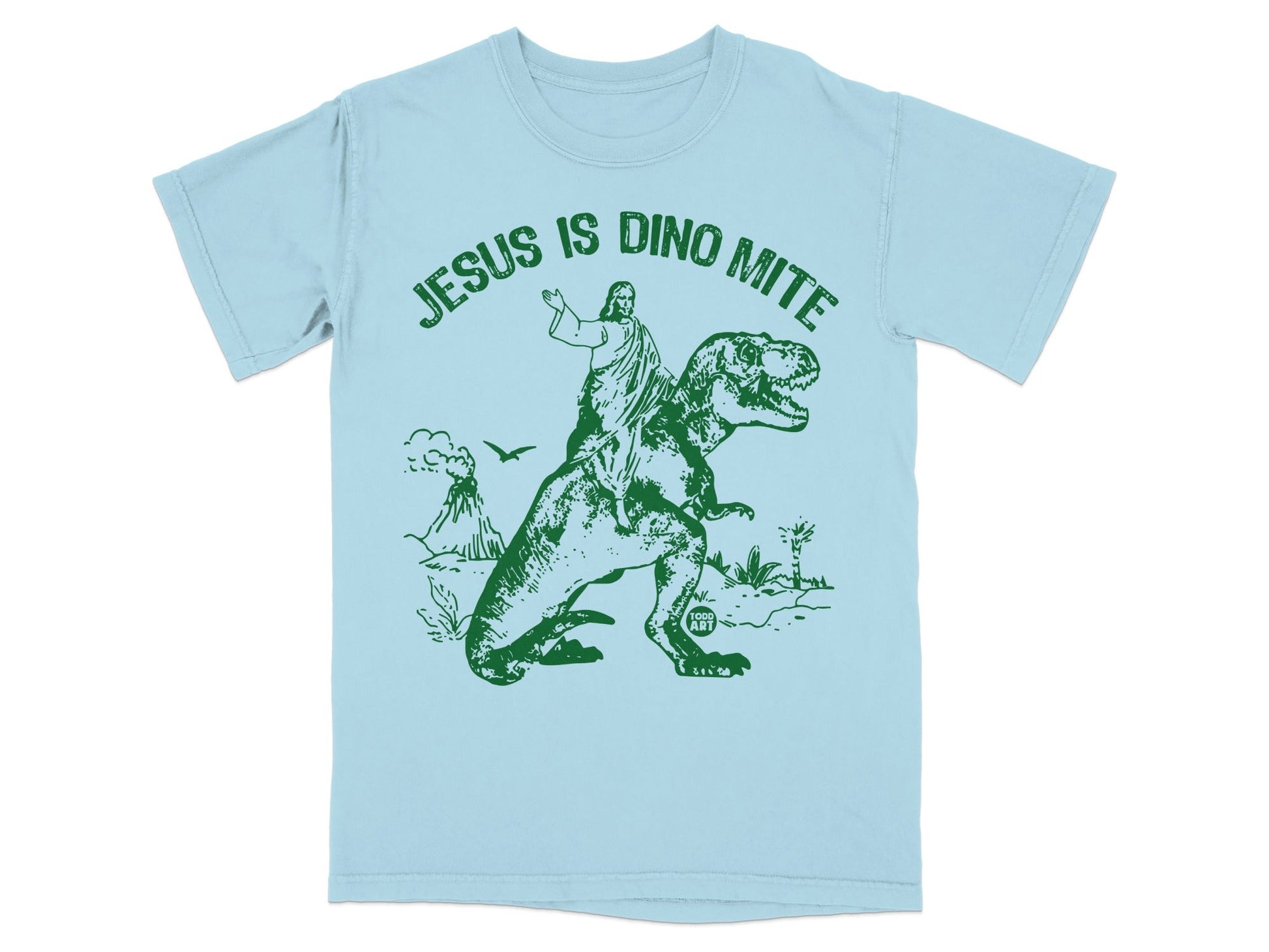 Jesus riding a dinosaur on a light blue t-shirt with text.