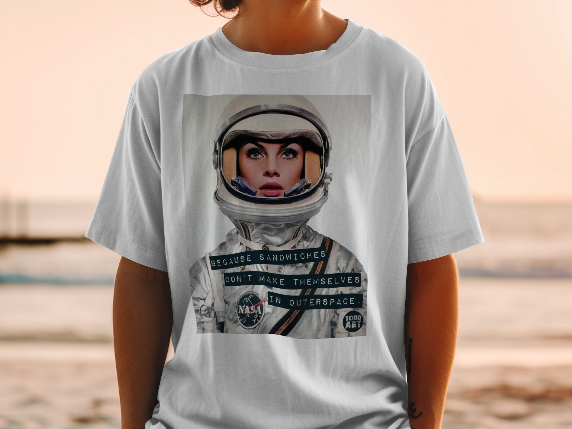 Woman in astronaut helmet with "NASA" and "Because sandwiches don't make themselves in outer space." text.
