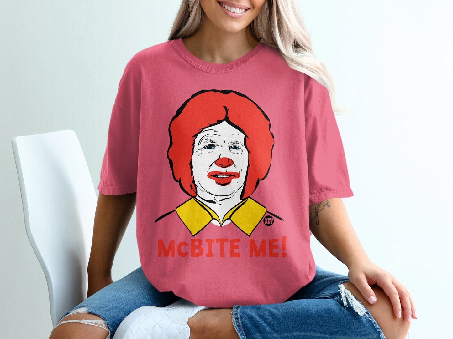 Pink t-shirt with a cartoon Ronald McDonald face and "McBITE ME!" text.
