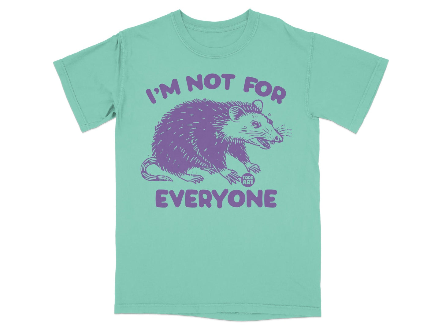 Purple rat graphic and text "I'm not for everyone" on a teal t-shirt.