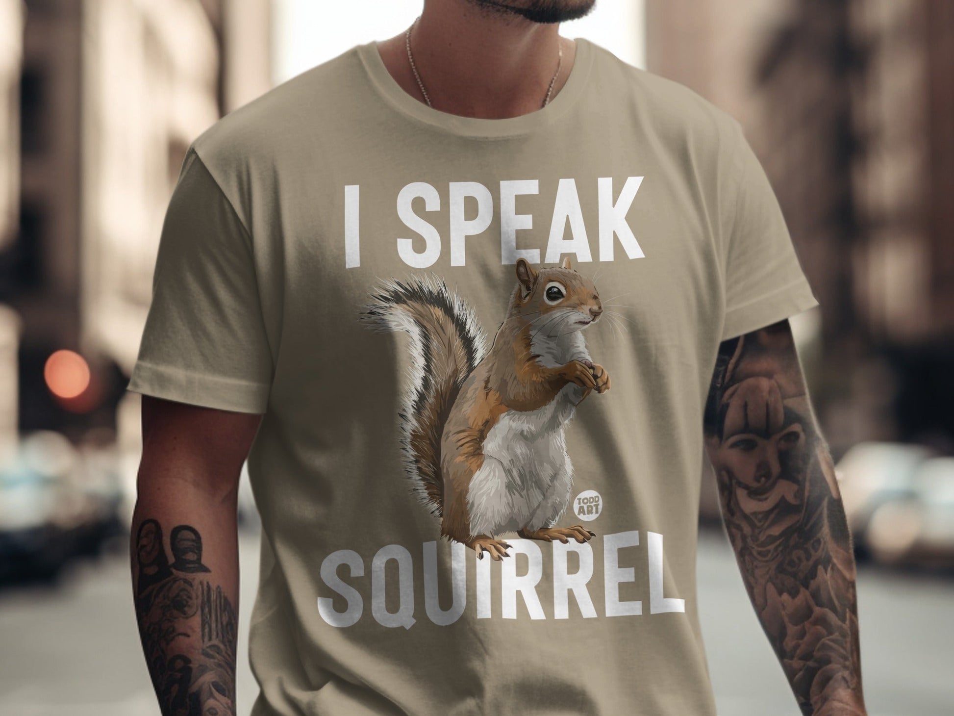 Beige t-shirt with "I SPEAK SQUIRREL" text and a squirrel illustration.