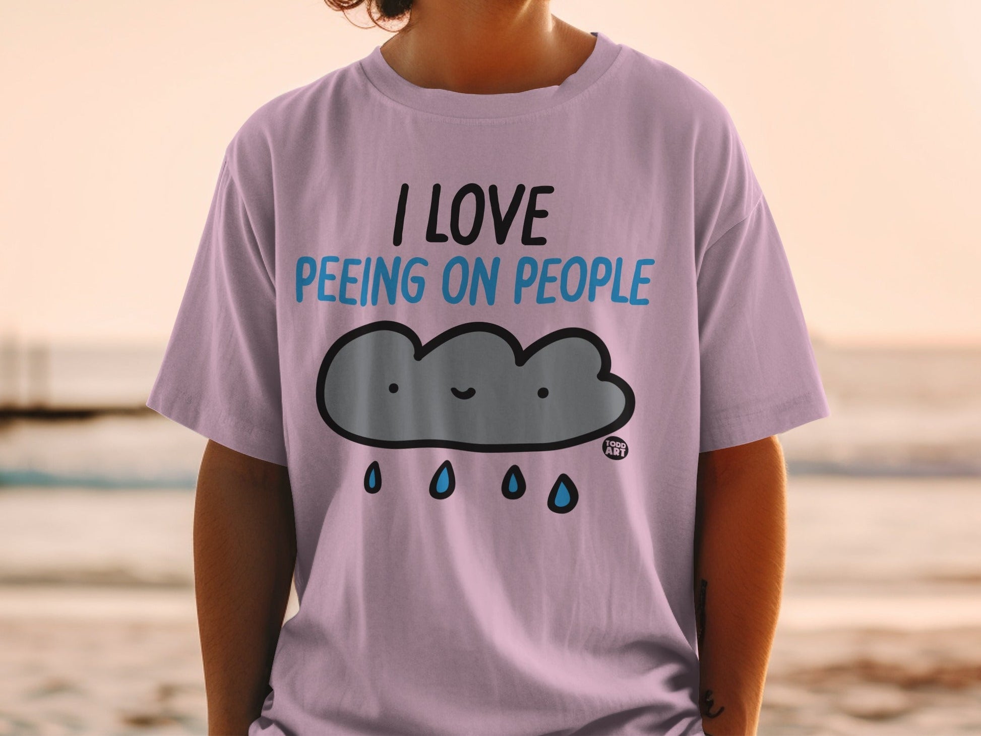 Light purple t-shirt with "I love peeing on people" and a cloud graphic.