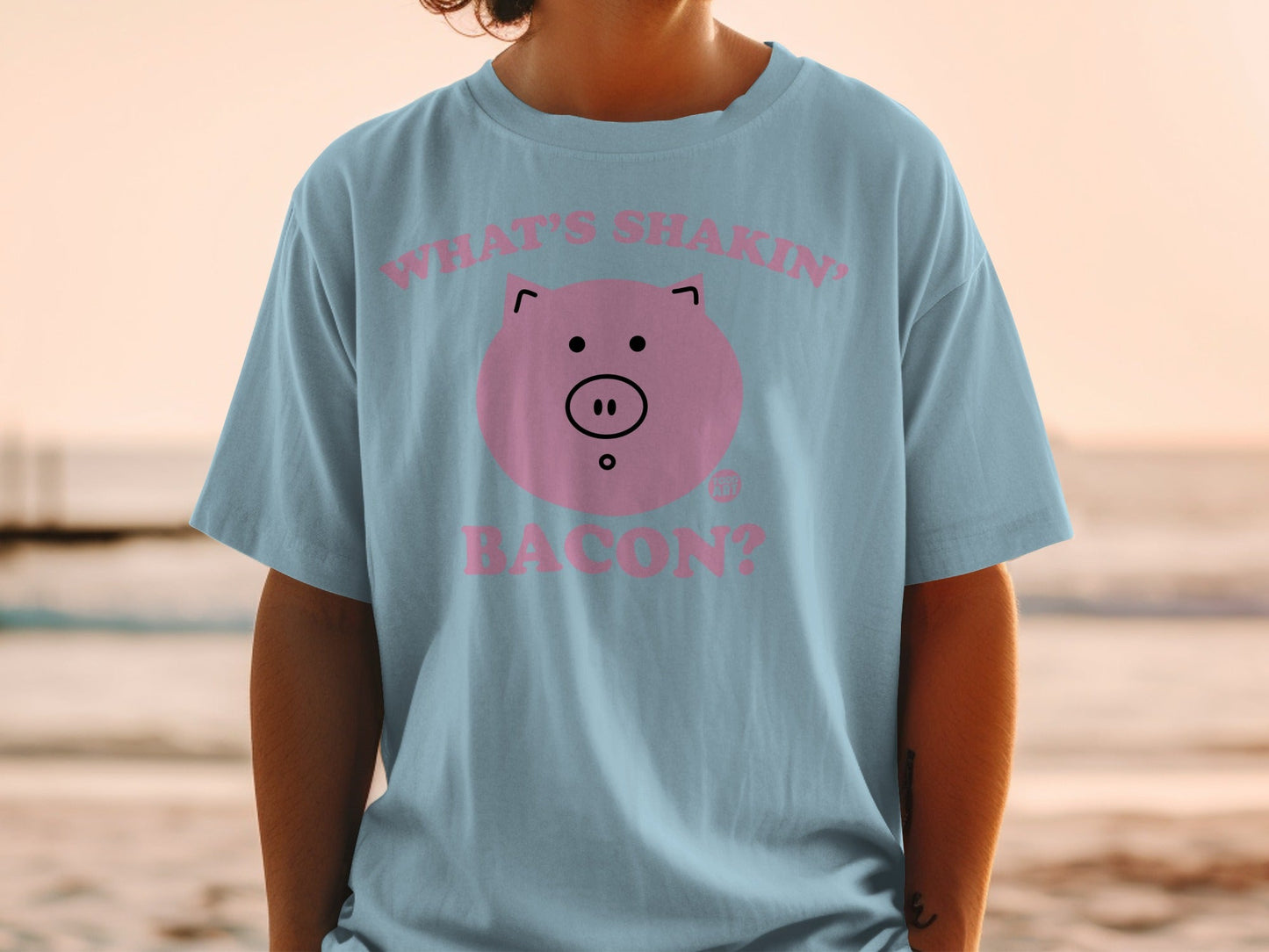 Light blue t-shirt with a pink pig face and "What's shakin' bacon?" text.