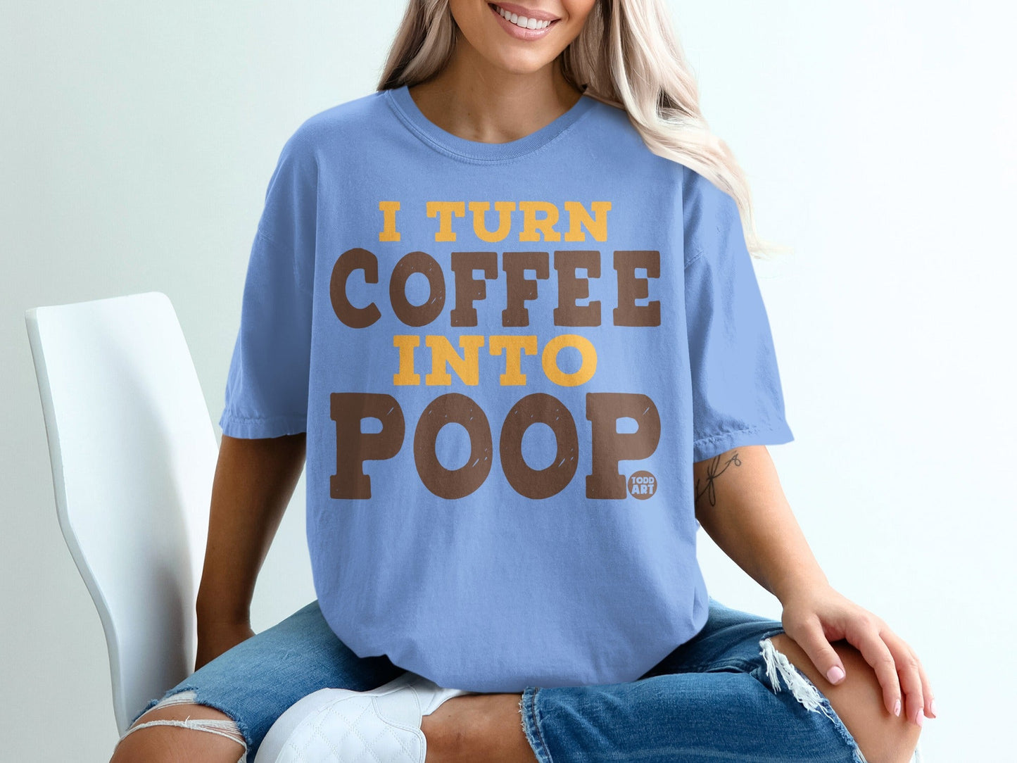 Light blue t-shirt with yellow text "I TURN COFFEE INTO POOP".