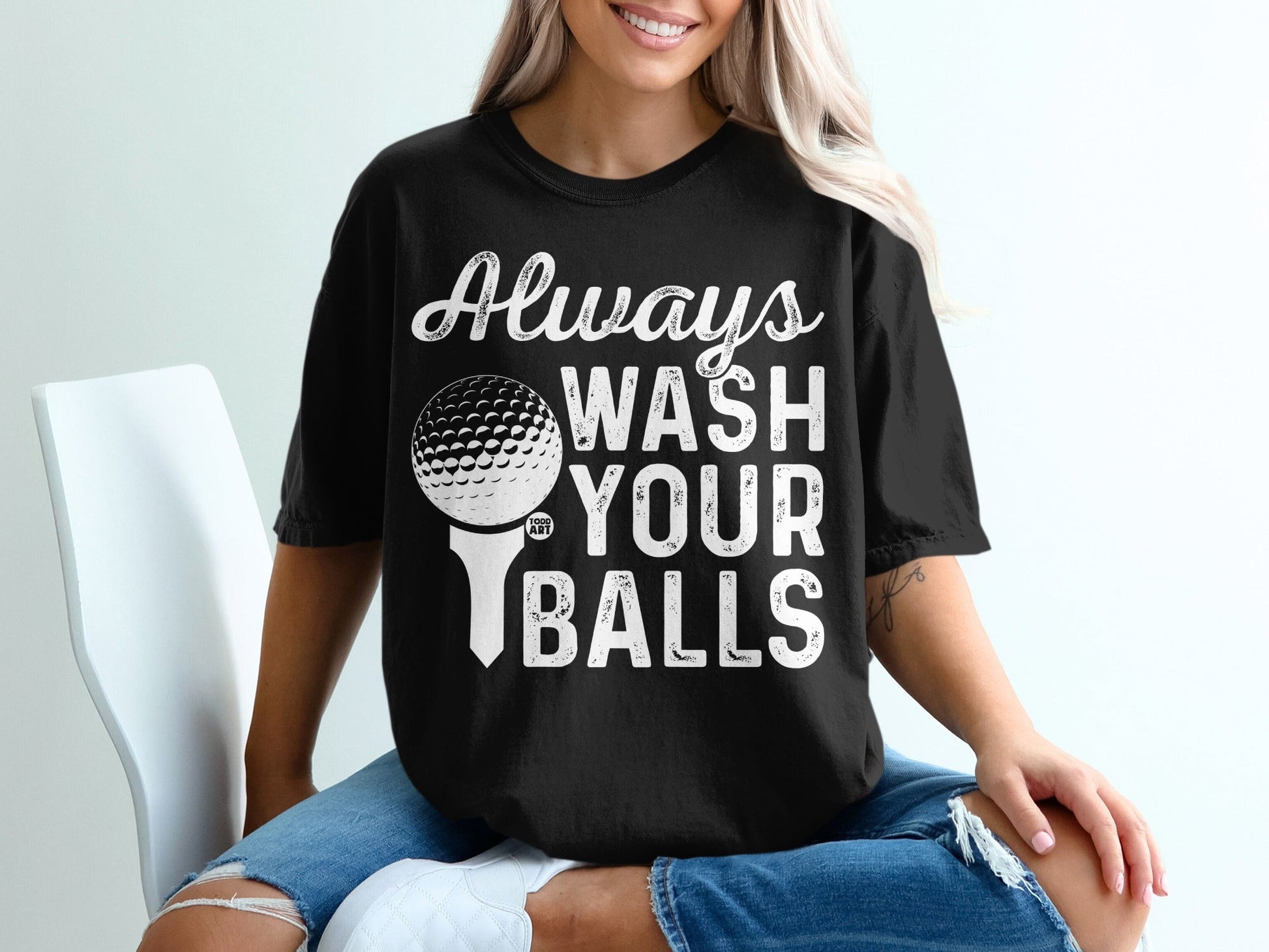Black t-shirt with white text "Always Wash Your Balls" and a golf ball on a tee.