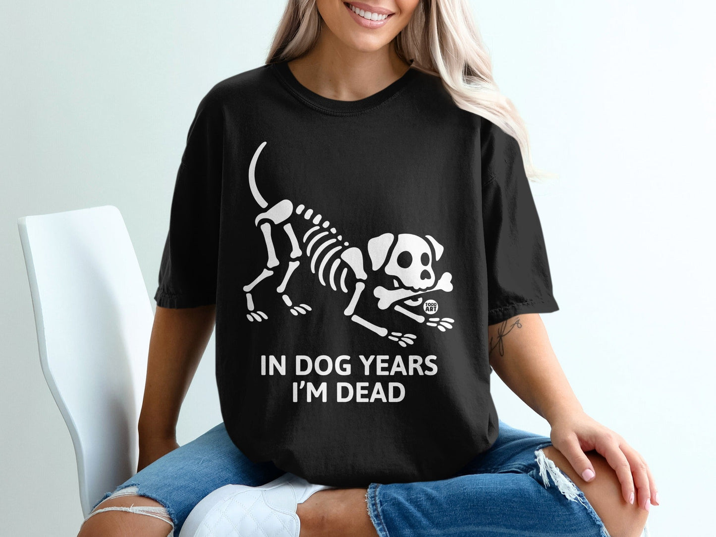 Black t-shirt with a white dog skeleton graphic and text "IN DOG YEARS I'M DEAD".