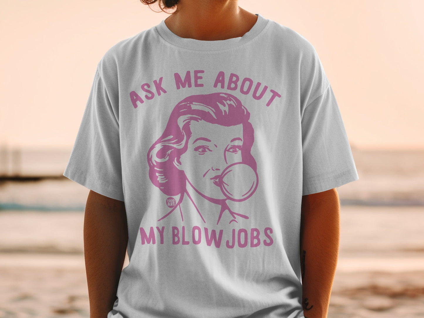 White t-shirt with graphic of woman blowing bubblegum, text: "ASK ME ABOUT MY BLOW JOBS".