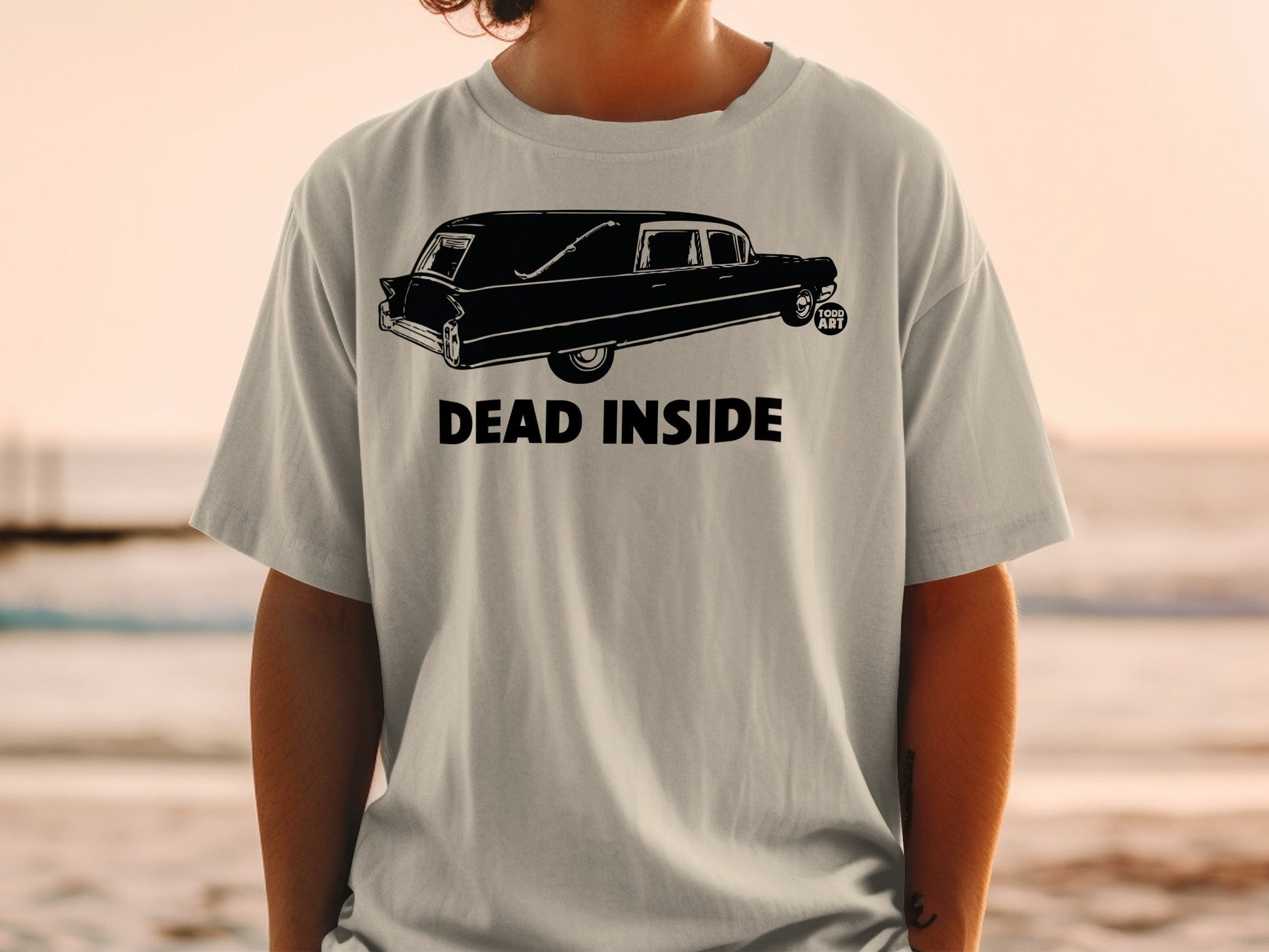 T-shirt with a hearse graphic and "DEAD INSIDE" text.