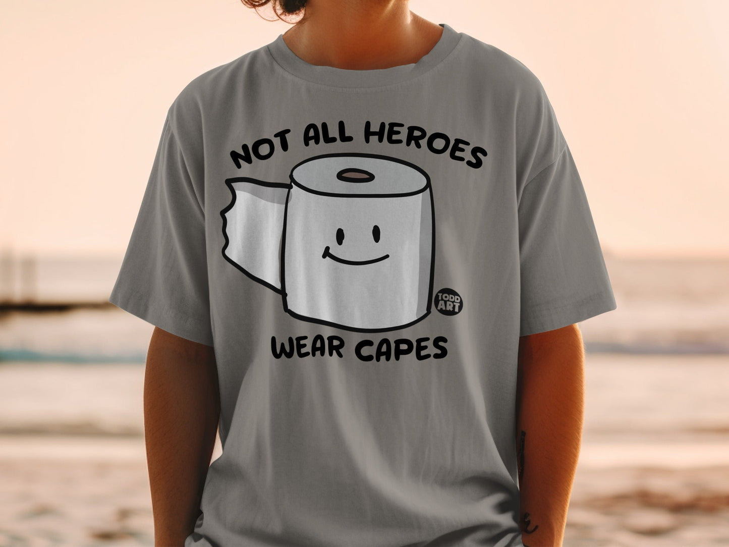 Gray t-shirt with a cartoon toilet paper roll wearing a smiley face and text.