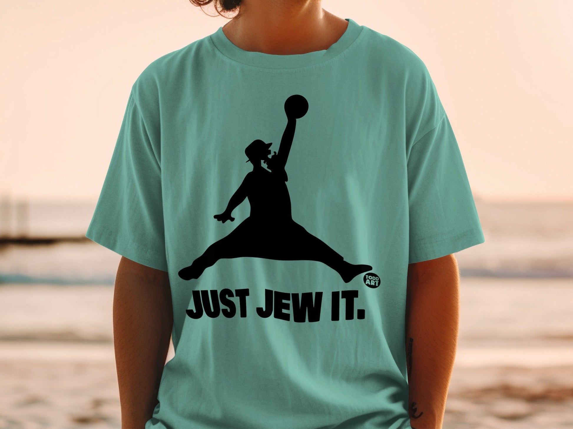Silhouette of a man in a hat mid-air, dunking a basketball, with "JUST JEW IT."