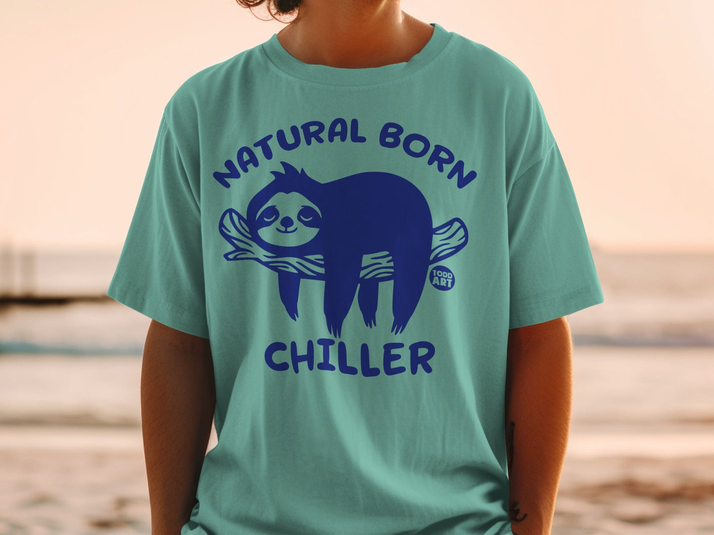 Turquoise t-shirt with a blue sloth graphic and "NATURAL BORN CHILLER" text.