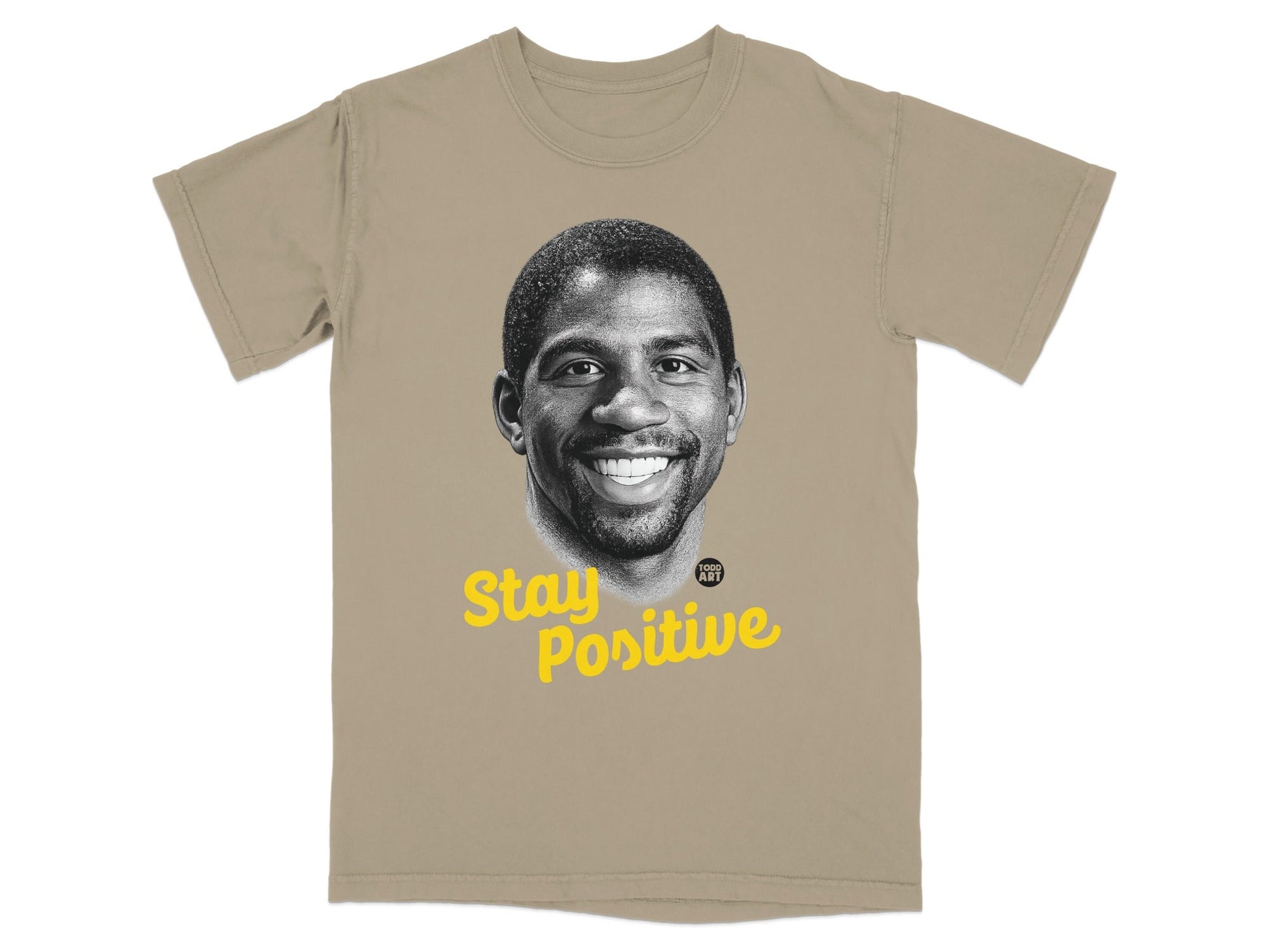 Magic Johnson portrait on a tan t-shirt with "Stay Positive" text.