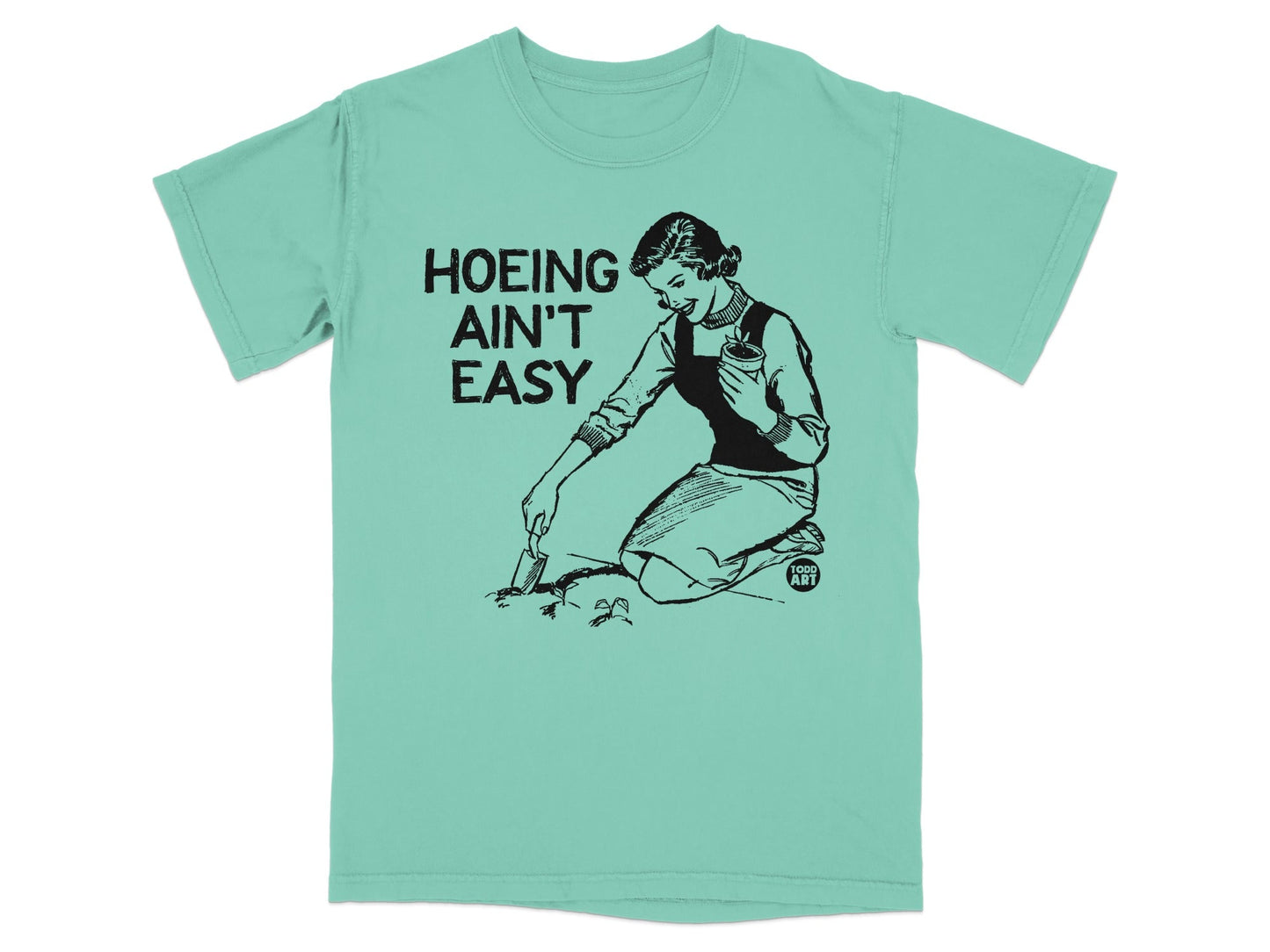 Woman gardening with text "Hoeing Ain't Easy" and "Good Art" logo.