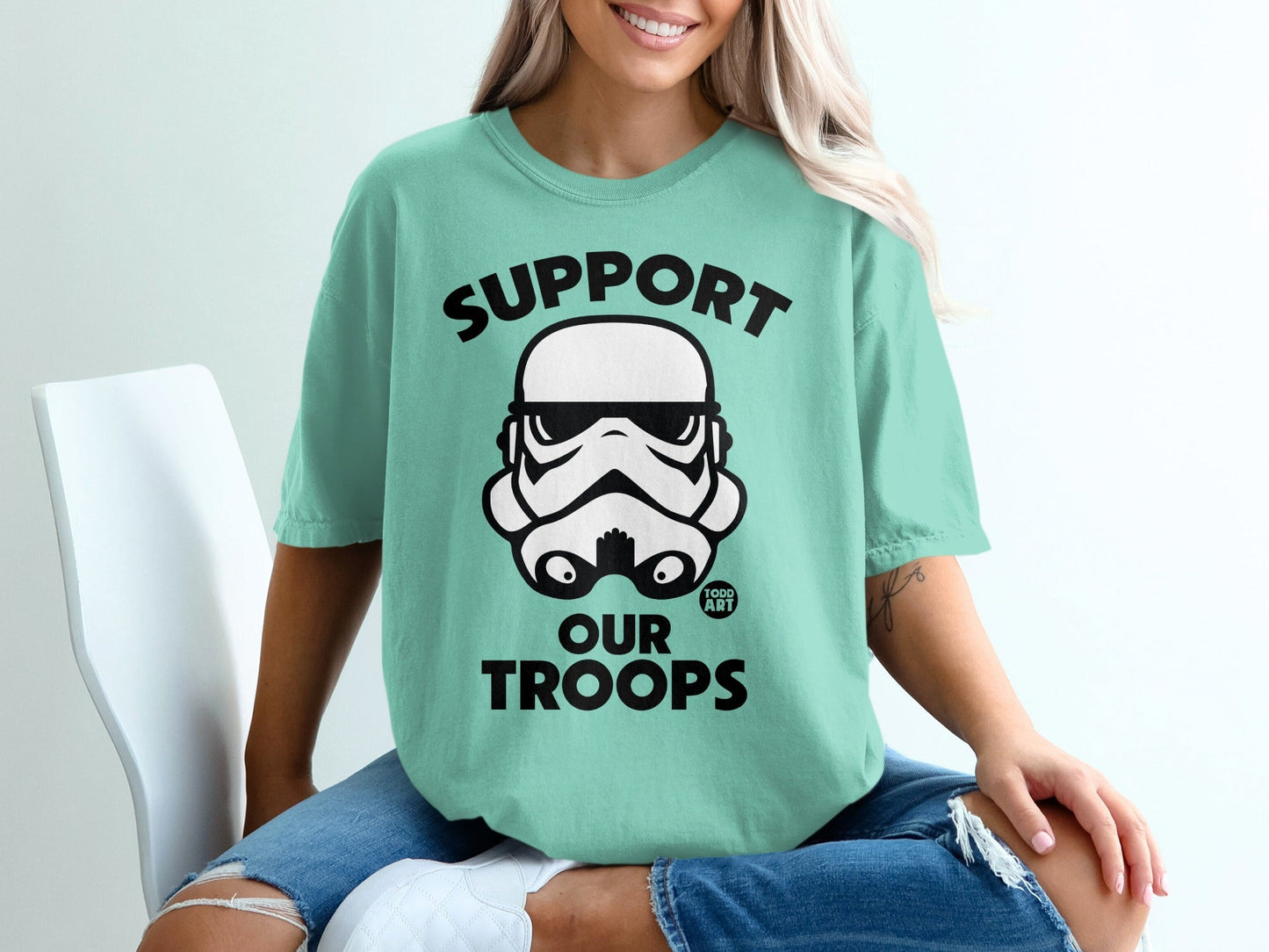 Teal t-shirt with "SUPPORT OUR TROOPS" and stormtrooper helmet graphic.