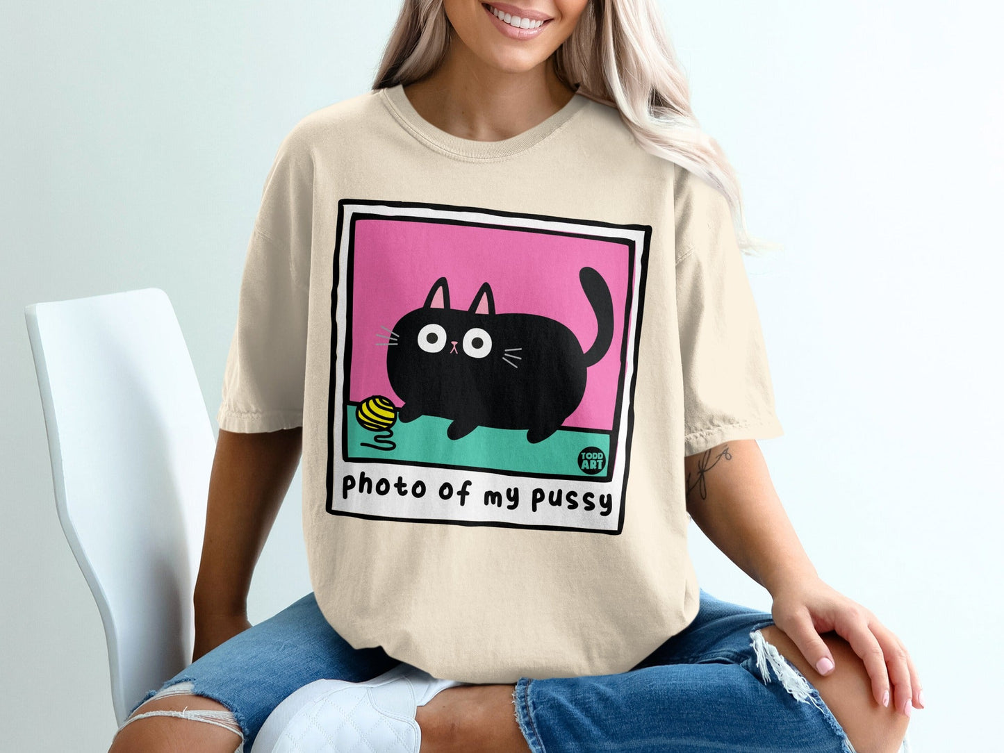 Beige t-shirt with black cat and yarn ball, "photo of my pussy" text.