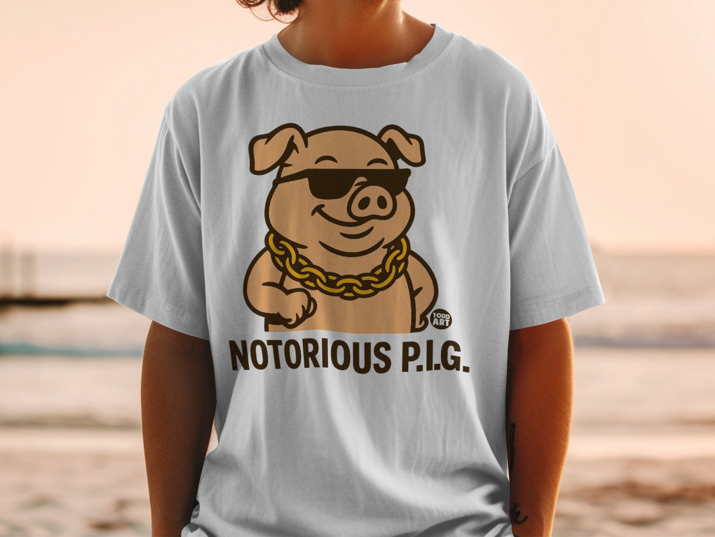 T-shirt with "Notorious P.I.G." text and cartoon pig wearing sunglasses and gold chain.