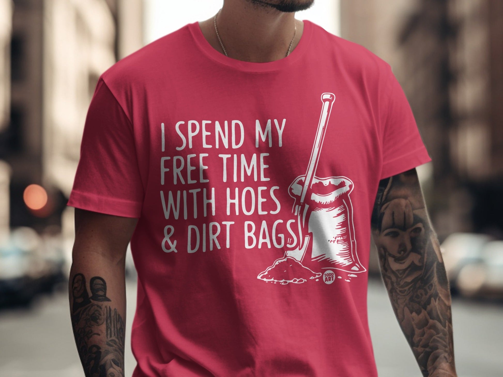 Red t-shirt with "I spend my free time with hoes & dirt bags" and shovel graphic.