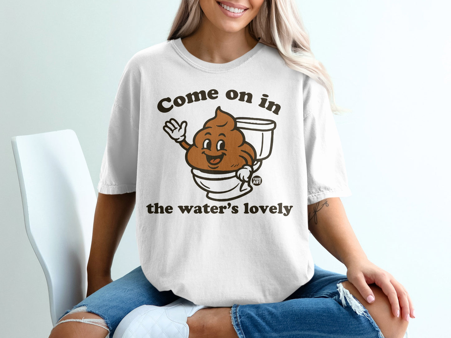 T-shirt with cartoon poop in toilet saying "Come on in the water's lovely".