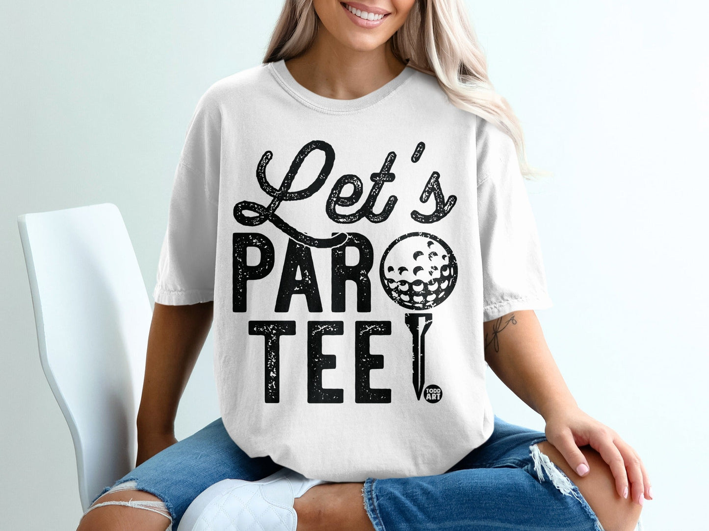 White t-shirt with "Let's PAR-TEE" and golf ball graphic.
