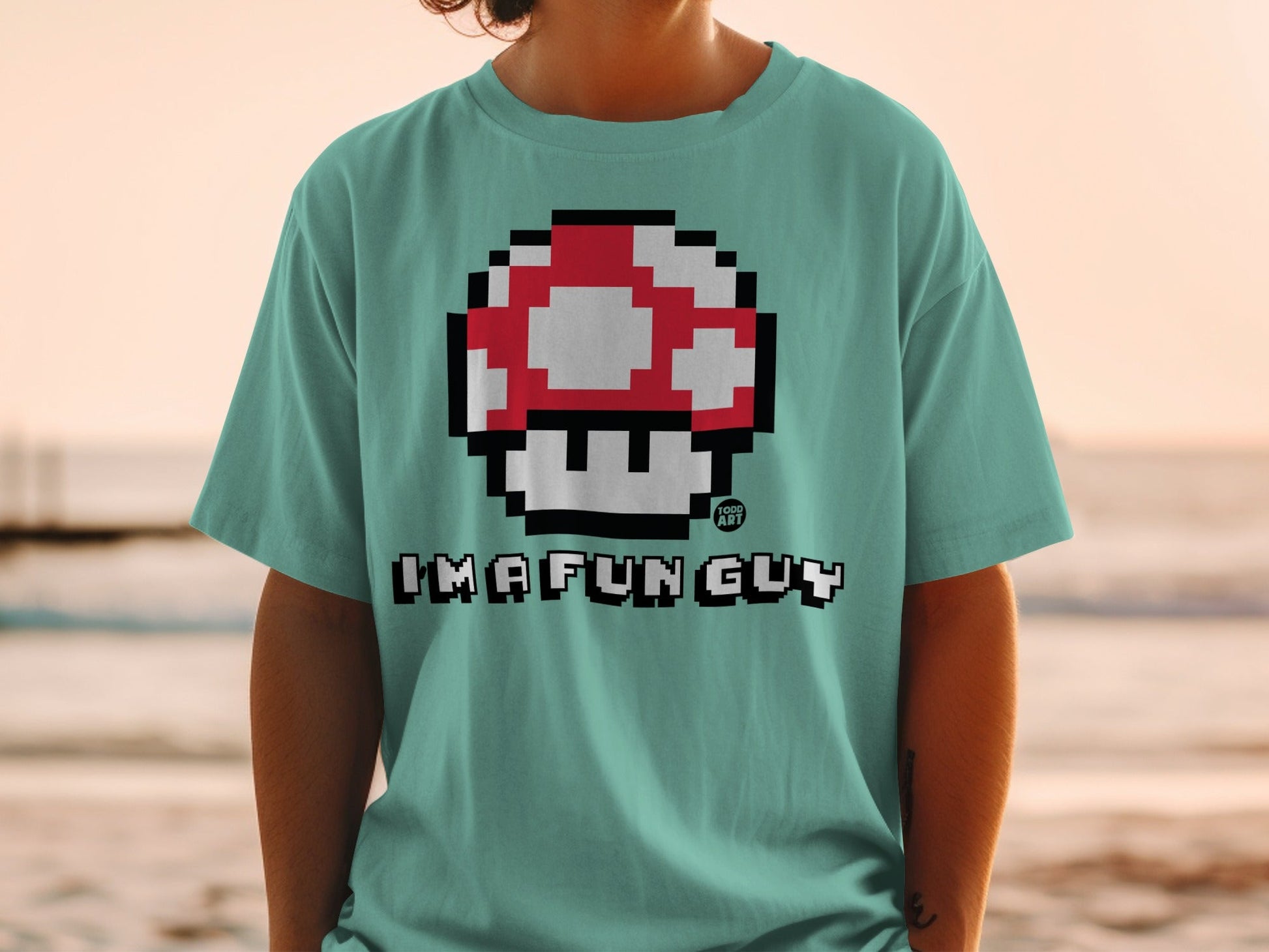 Mint green t-shirt with pixelated red and white mushroom and "IMAFUNGUY" text.