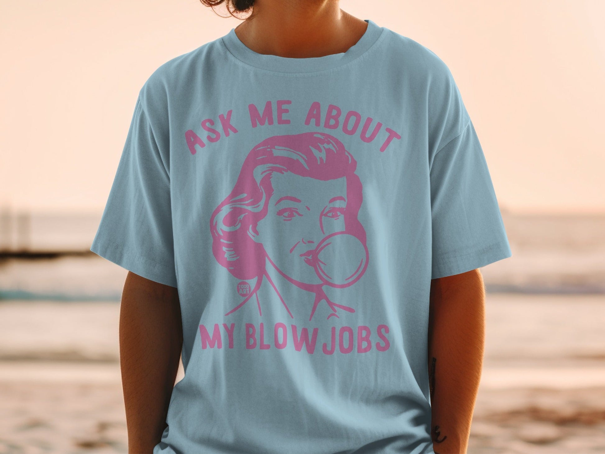 Light blue t-shirt with pink graphic: "ASK ME ABOUT MY BLOW JOBS".