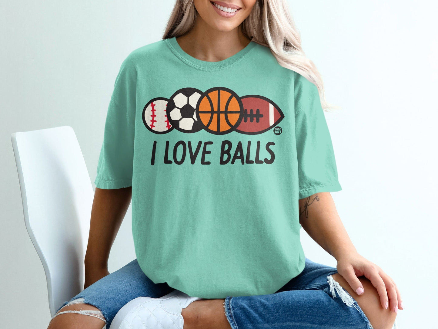 Teal t-shirt with "I LOVE BALLS" and various sports balls.