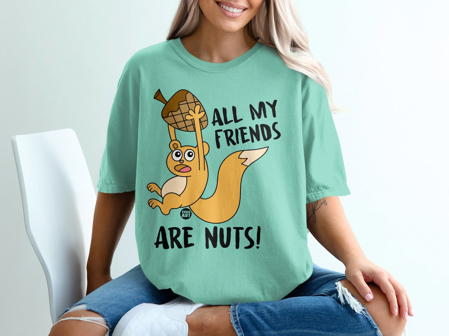Teal t-shirt with cartoon squirrel holding acorn, "All my friends are nuts!"