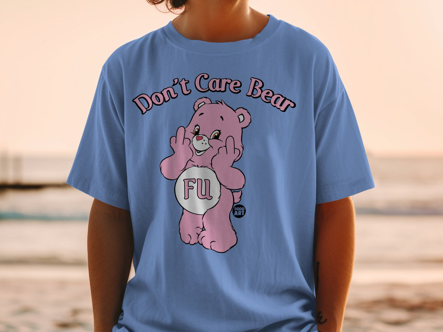 Pink Care Bear t-shirt with "Don't Care Bear" text and middle finger gesture.