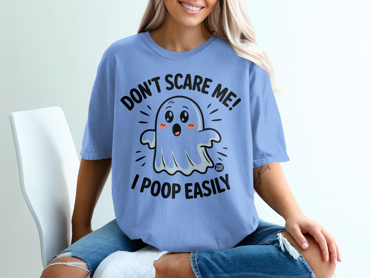 Blue t-shirt with cartoon ghost saying "Don't scare me! I poop easily."