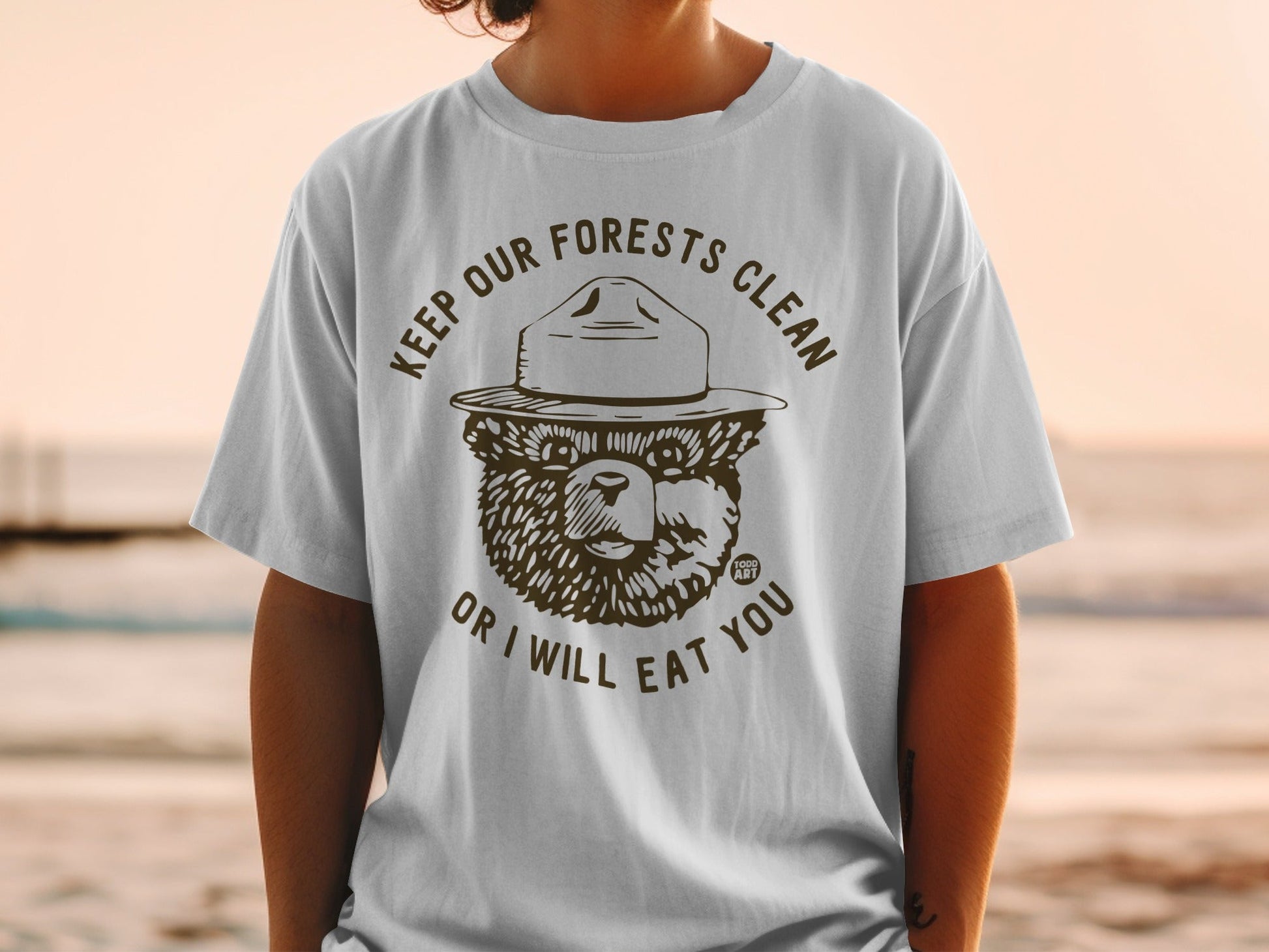 Smokey Bear wearing a hat, saying "Keep Our Forests Clean Or I Will Eat You".