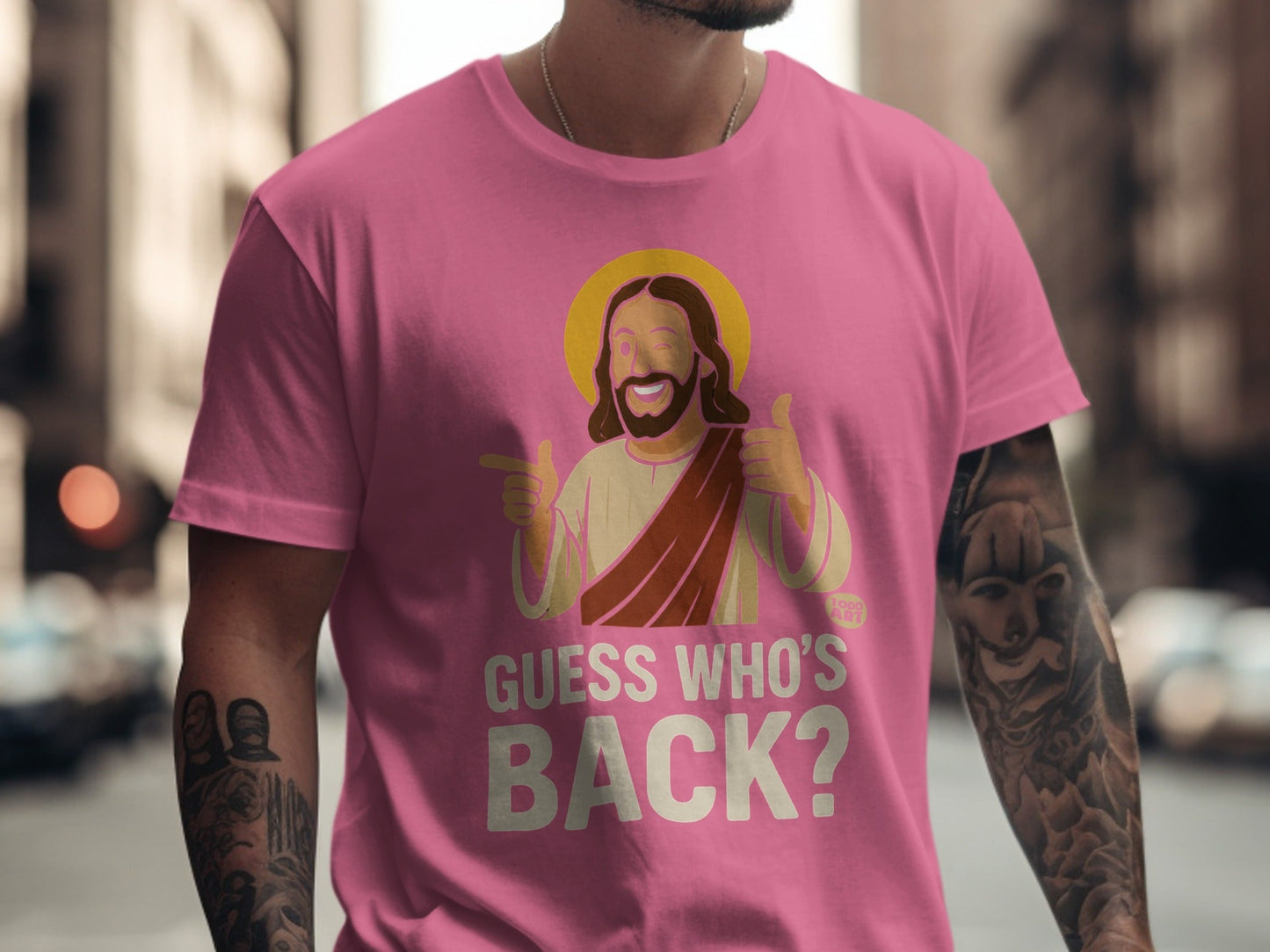 Pink t-shirt with cartoon Jesus giving thumbs up, text "GUESS WHO'S BACK?".