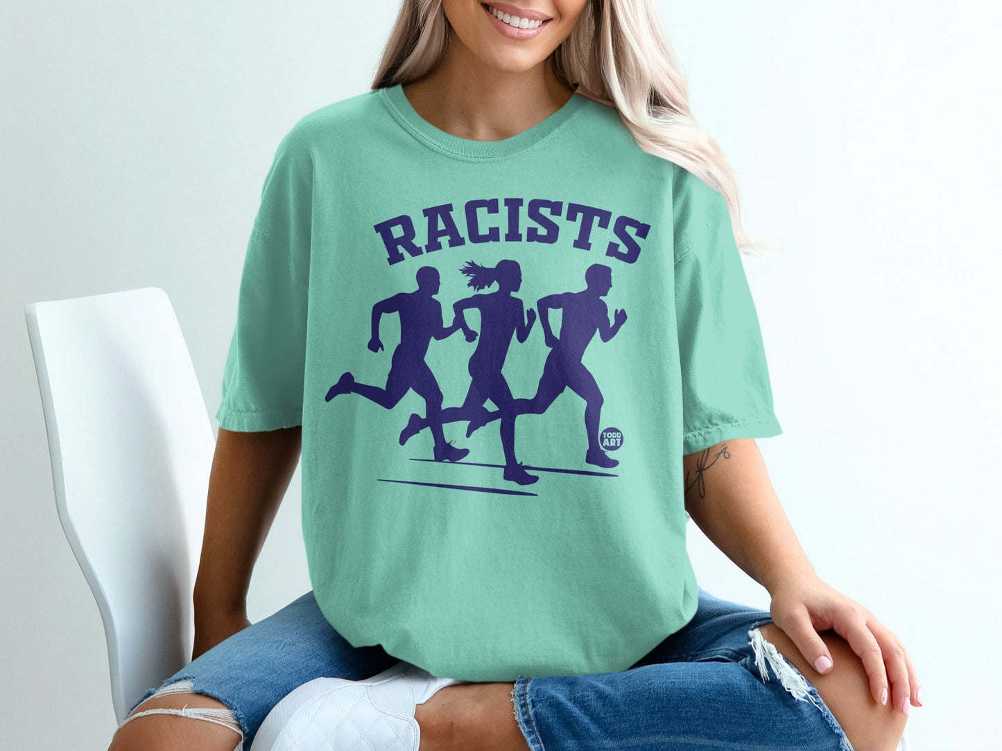 Teal t-shirt with "RACISTS" and three running figures graphic.