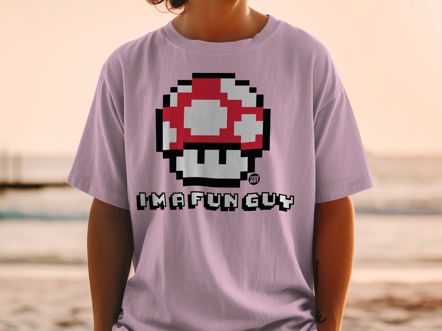 Pink t-shirt with Super Mario mushroom graphic and "I'M A FUN GUY" text.