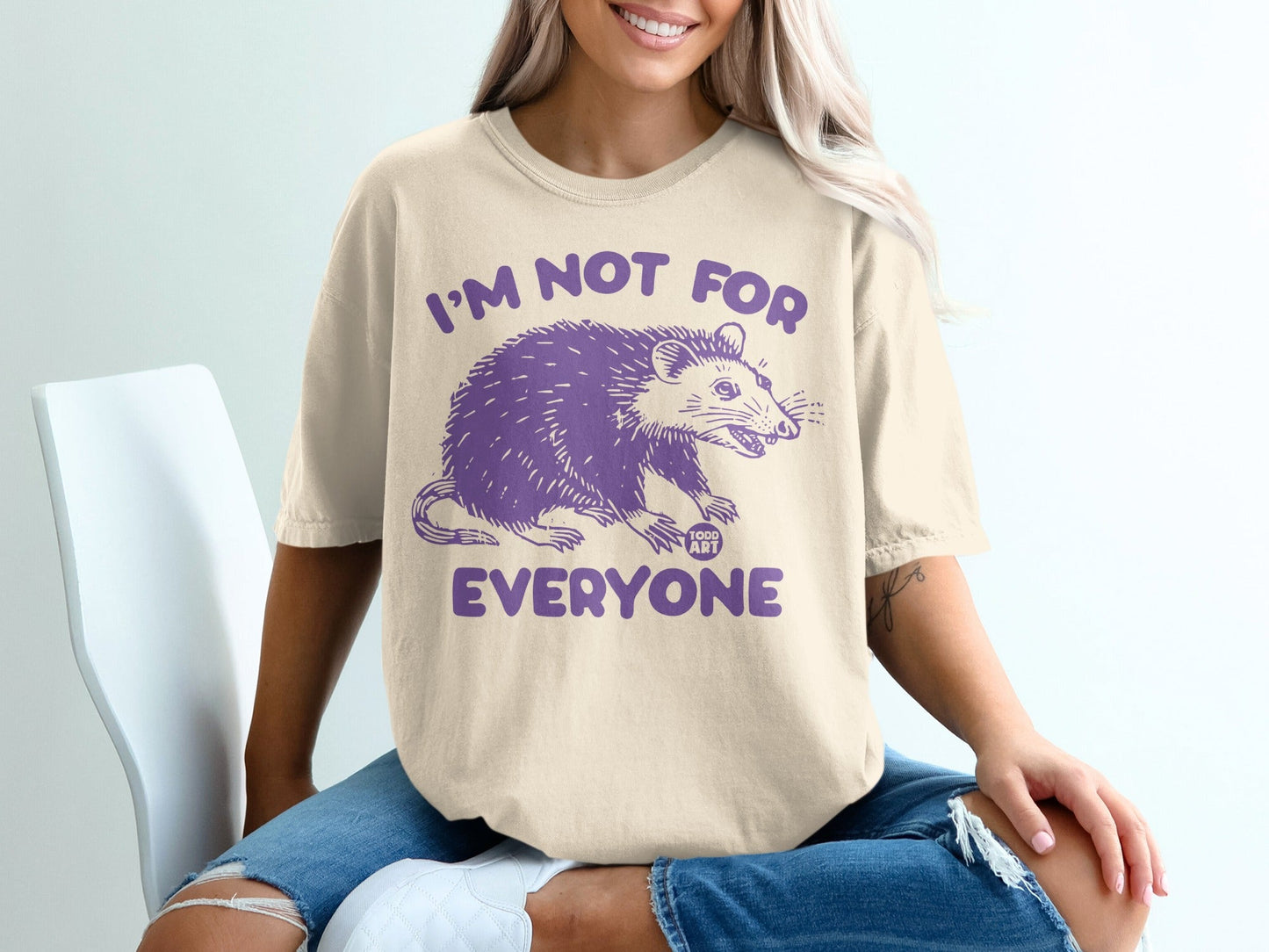 Cream t-shirt with purple possum graphic and "I'm not for everyone" text.